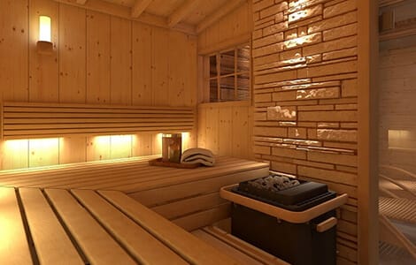 Le sauna finlandais en bois avec bancs et pierres volcaniques