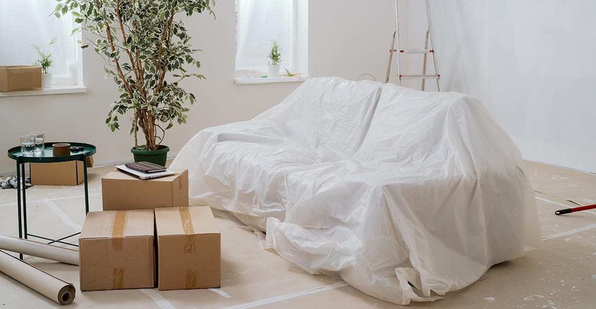 un salon bâché avant travaux de peinture